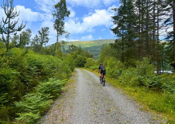 Male cyclist riding a gravel trail in Scotland