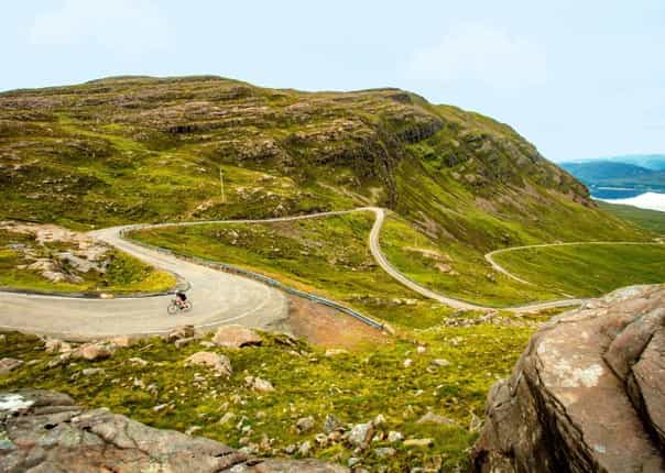 Cyclist on the Bealach na Ba road in the Scottish Highlands