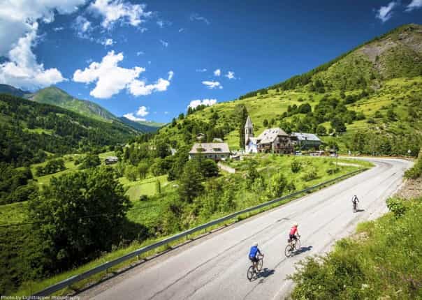 Road cyclists ascending a mountain road in the French Alps