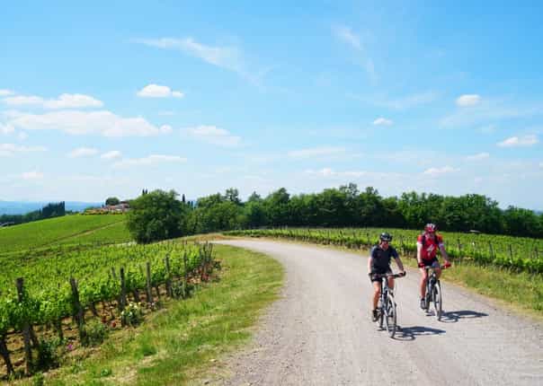 Two cyclists mountain biking in Tuscany along the Via Francigena