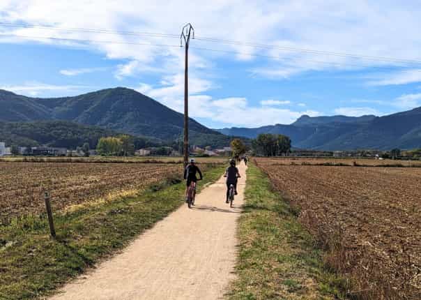 Two cyclists riding the scenic Vias Verdes cycle path in Catalonia, Spain