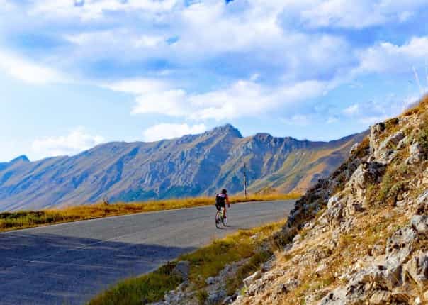 Road cyclists climbing in Gran Sasso park on a guided cycling tour in Italy